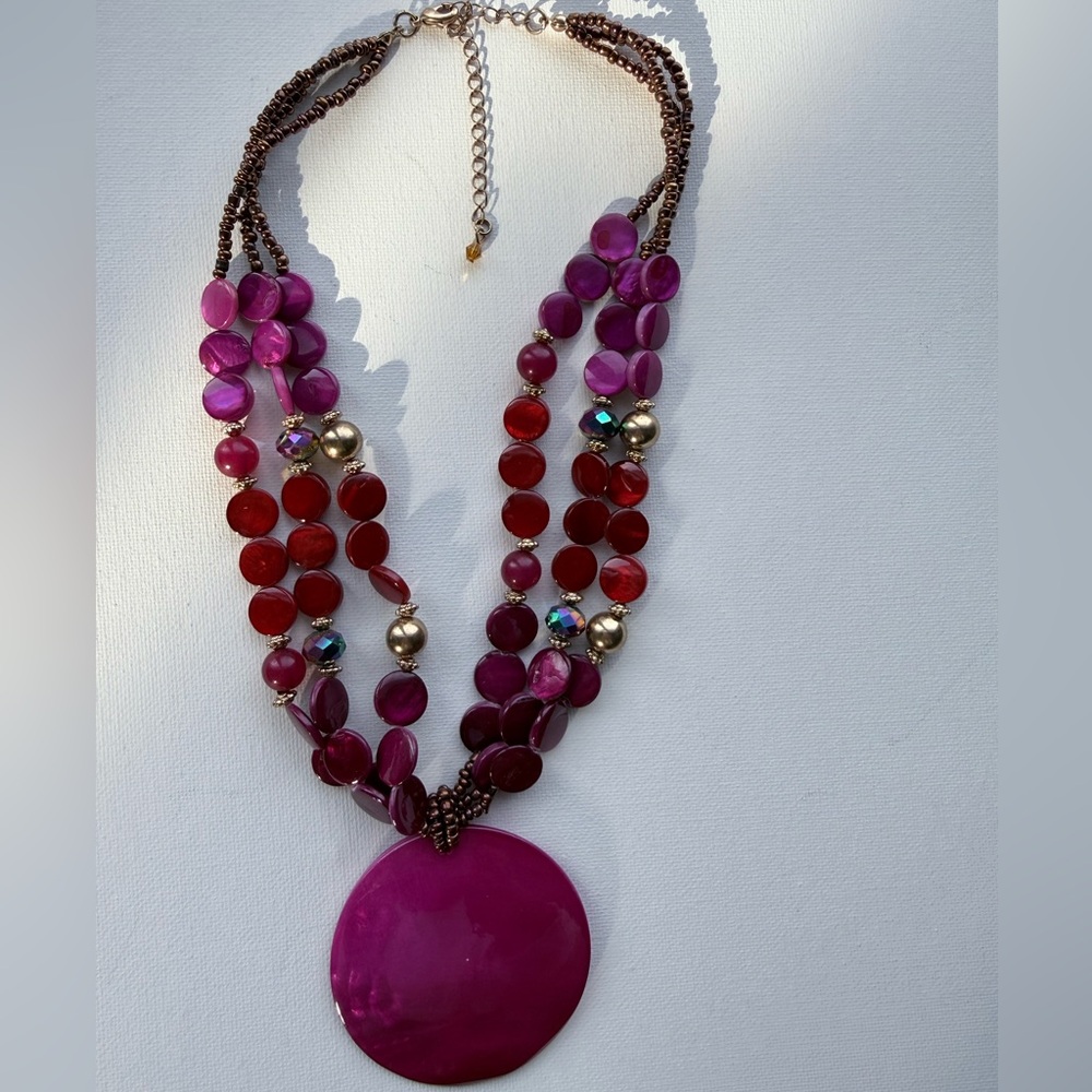 Vibrant statement necklace in magentas and reds with gold